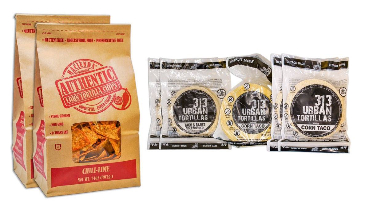 Image: A display featuring two bags of Hacienda Authentic Urban Chili Lime tortilla chips on the left. To the right, there are two bags of 313 Urban 6" Flour Tortillas, one bag of 313 Urban Yellow Corn Tortillas, and two bags of 313 Urban White Corn Tortillas, all labeled "Detroit Made."