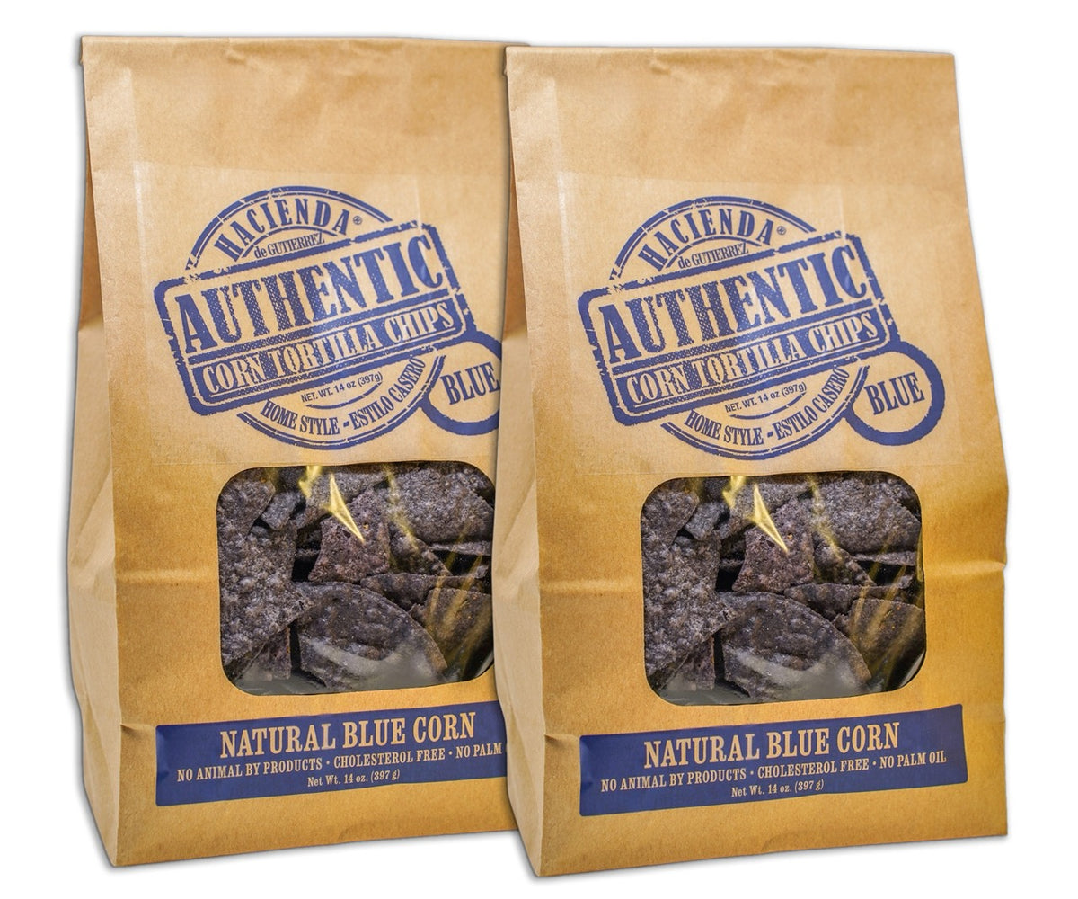 Two bags of Hacienda Authentic Corn Tortilla Chips labeled "Blue," with a clear window displaying the blue corn chips inside, emphasizing their "Home Style" quality and being "Detroit Made."