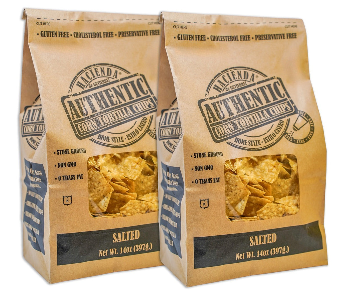 Two bags of Hacienda Authentic Corn Tortilla Chips labeled "Salted," showcasing the chips through the clear windows, with branding that emphasizes their "Home Style" quality and "Detroit Made" origins.