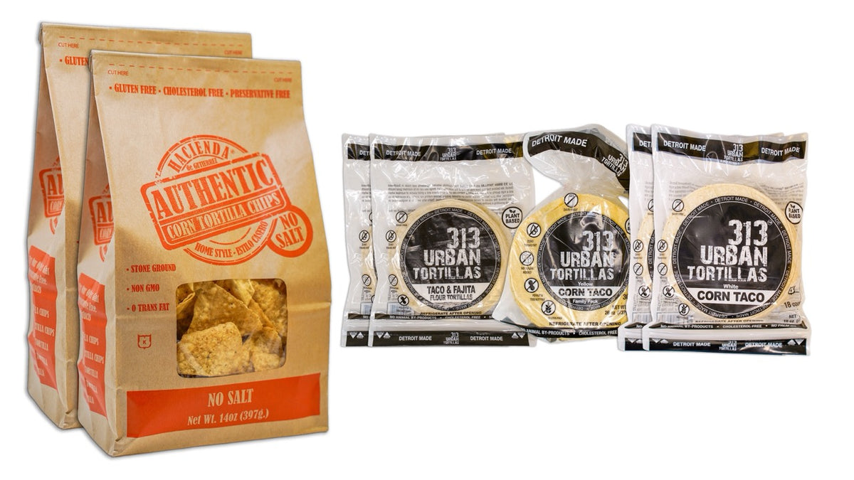 Image: A display featuring two bags of Hacienda Authentic No Salt tortilla chips on the left. To the right, there are two bags of 313 Urban 6&quot; Flour Tortillas, one bag of 313 Urban Yellow Corn Tortillas, and two bags of 313 Urban White Corn Tortillas, all labeled &quot;Detroit Made.&quot;