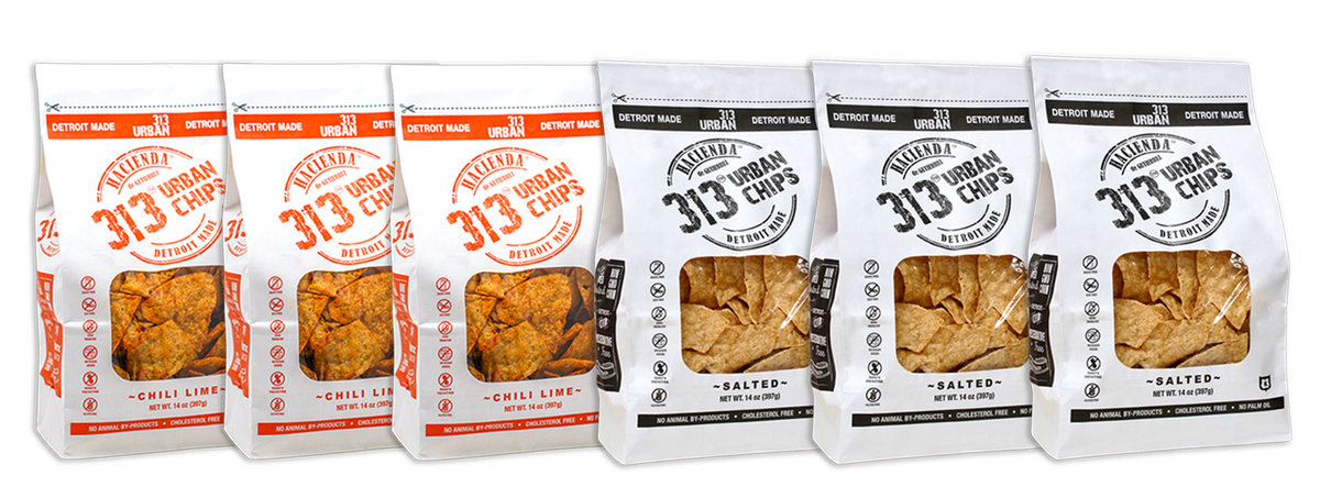 A display featuring six bags of Hacienda 313 Urban Chips. The first three bags are labeled &quot;Chili Lime&quot; with vibrant red labeling and a transparent window showing the chips inside. The final three bags are labeled &quot;Salted&quot; in black, also with transparent windows to view the contents. All bags prominently feature &quot;DETROIT MADE&quot; on the packaging.